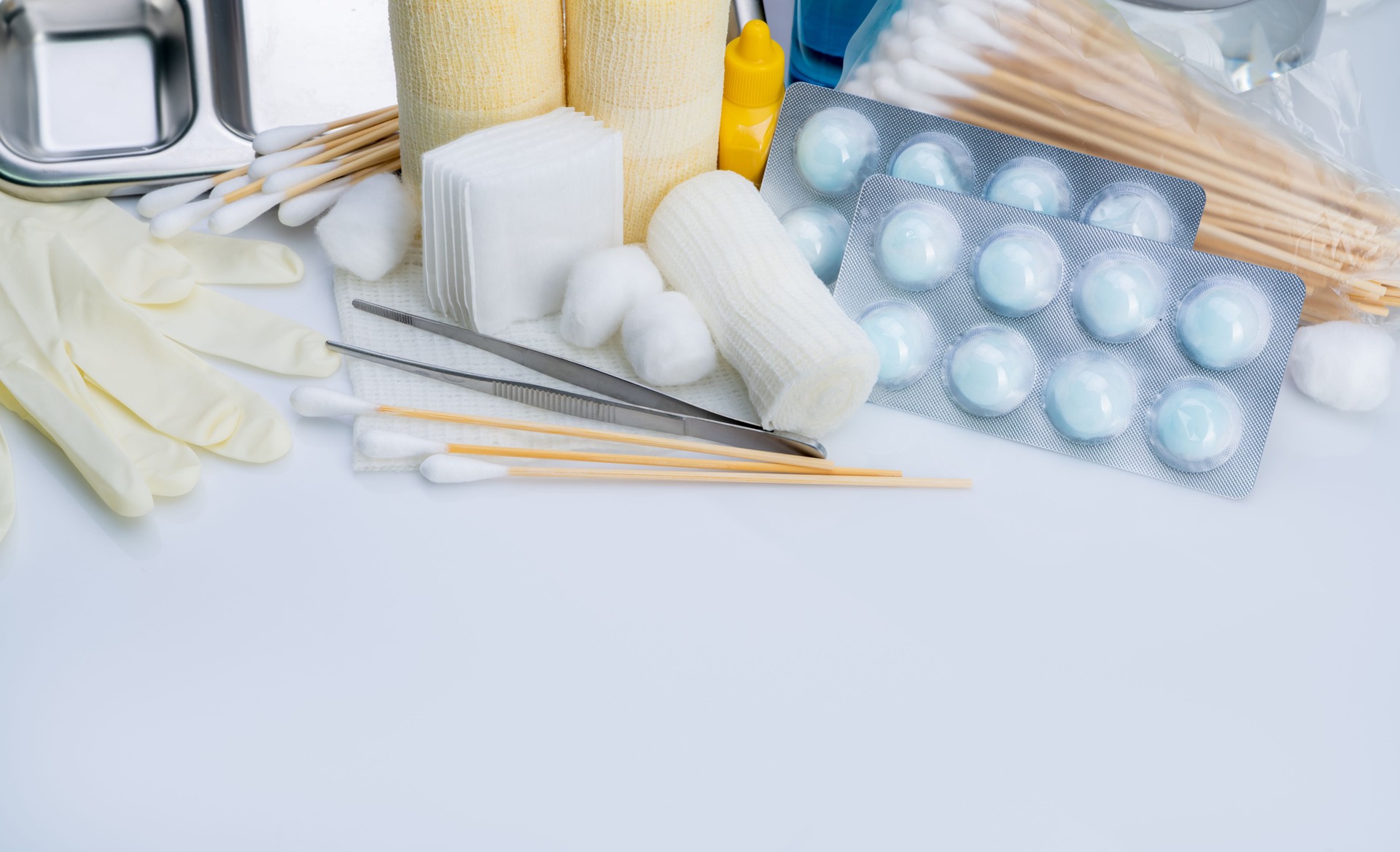 Wound care dressing set. Medical supply for diabetes, surgical and accidental wounds care. Medical equipment for nurse. Forceps, cotton stick, conform bandage, povidone-iodine bottle and latex gloves.